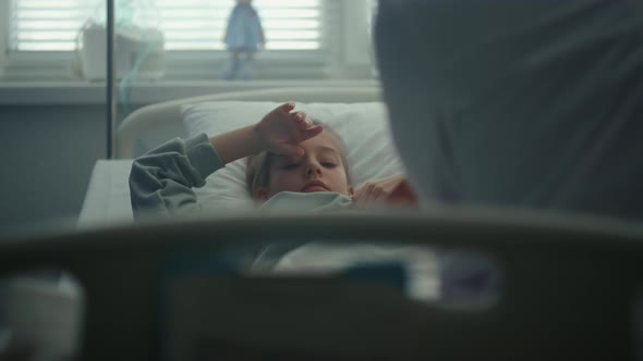Sad Girl Lying Hospital Bed on Daily Medical Examination in Clinic Portrait alt