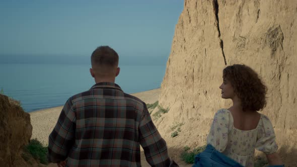 Couple Going Down Coast to Sandy Beach alt