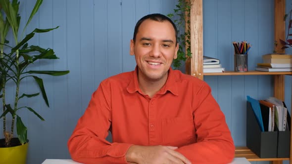 Portrait of Happy Young Businessman Sitting at Table in Home Office alt