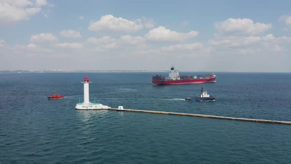 Shipping containers Cargo Vessel passing Lighthouse