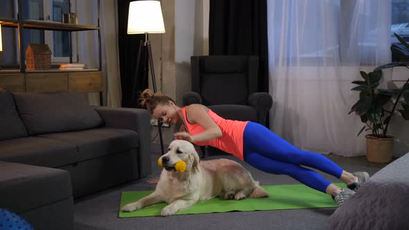 Sporty Woman Making Side Stand Exercise with Dog alt
