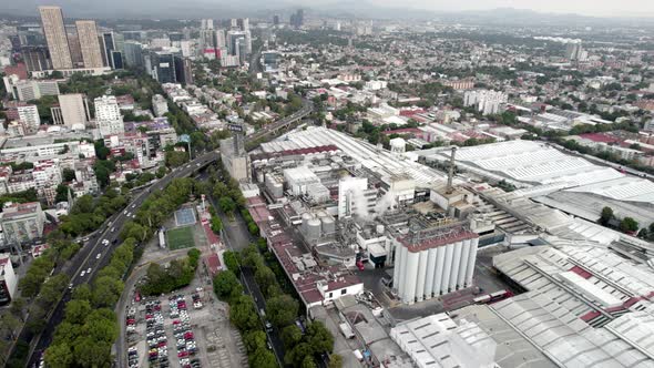 rotational drone shot of a beer factory in the industrial heart of mexico city alt