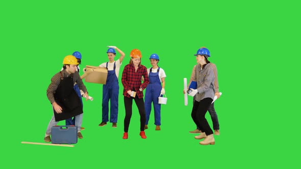 Funny Multi Ethnic Construction Team Dancing One is Showing Off on a Green Screen Chroma Key