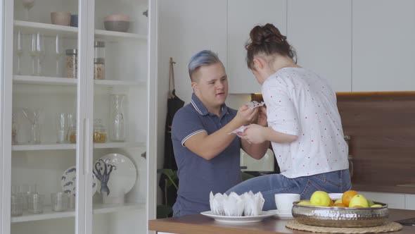 Young Couple with Down Syndrome In Love at Kitchen