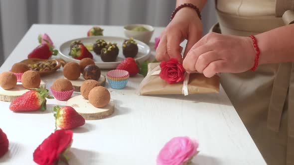 Woman decorating desserts and packing it