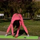 Young attractive multi ethnical woman wearing pink sportswear, pants and top, doing stretching yoga - VideoHive Item for Sale