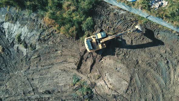Aerial View on Top Work of an Excavator That Clears and Levels the Area alt
