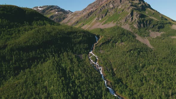 Stunning mountain landscape with river and waterfalls in arctic, aerial dolly in alt
