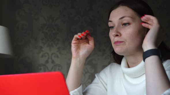 Woman Communicates By Video Call, Conference, Working at Home, on a Laptop