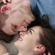 Young Loving Couple Lying on Bed at Home - VideoHive Item for Sale