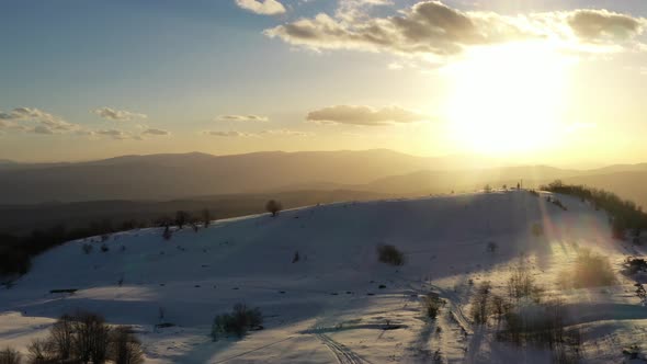 Aerial view at the mountain on a sunset of the winter day