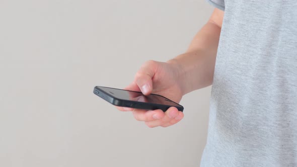 Close up man hands texting message on mobile smart phone alt