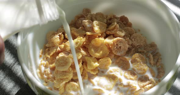 Milk Pouring Into a Bowl of Cereal Splashing in Slow Motion