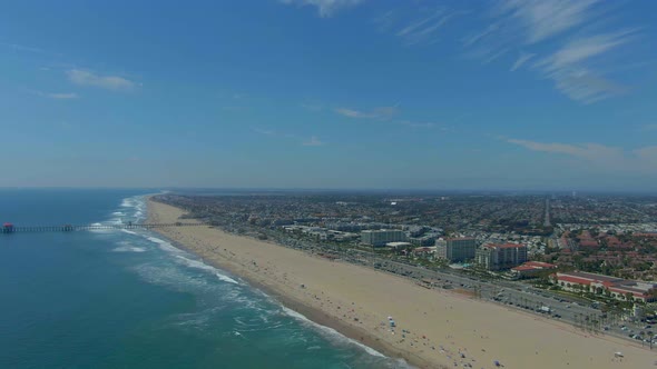 Flying over Huntington Beach with a view of the Ocean and PCH. alt