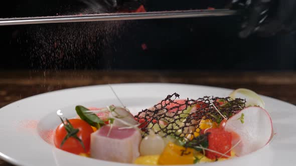 Chef at Restaurant Kitchen Serves Dish Adds Final Ingredient and Spices alt