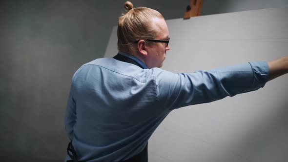 Art Studio Creative Adult Man at Work a Talented Men Artist Makes Sketches on Canvas with a Pencil alt