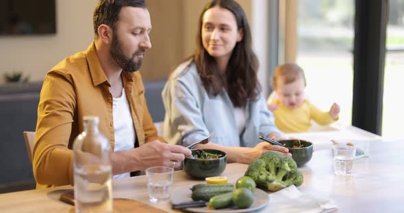Young Family with a One Year Baby Boy During a Lunch Time at Home