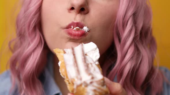 Closeup of Attractive Cheerful Hungry Famale Girl with Pink Hair Hairstyle Enjoying Biting Tasty