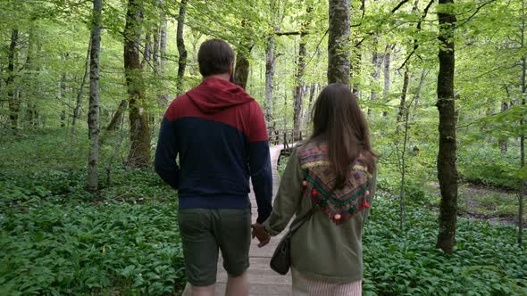 Couple Walking Along a Forest Path