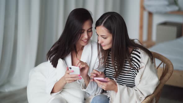 Close Up, Two Girls Shop Online, Enter Data Into Phone From Bank Card alt