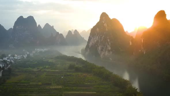 Aerial shot of the amazing rock formations along the Li River in China alt