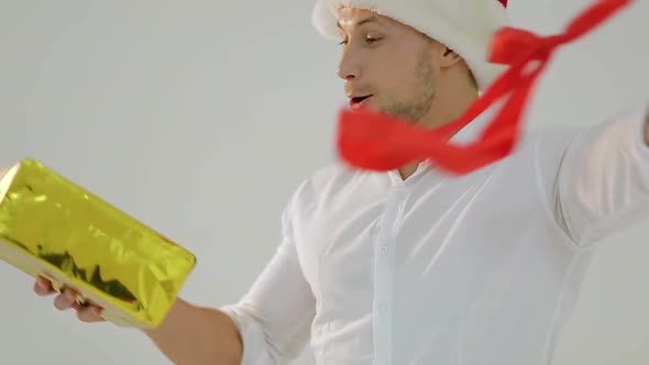 A man in Santa's hat is rocking a Christmas deal. Morning before Christmas. alt