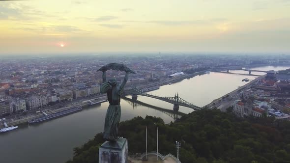 Flying Around of Statue of Liberty with the Skyline of Budapest at Background.