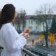 Photo of a beautiful girl in a bathrobe on the hotel balcony with a cup of coffee. - VideoHive Item for Sale