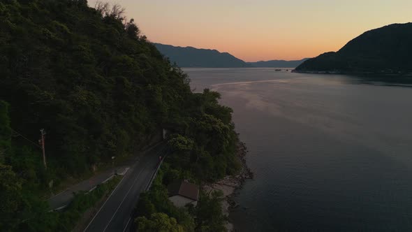 A modern car driving along a street at the shore of Lake Lago Maggiore in Italy and Switzerland seen alt