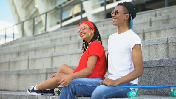 Cute Couple of Mixed-Race Teenagers Hugging and Sincerely Smiling Outdoor alt
