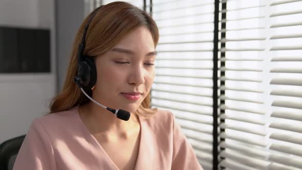 Competent Female Operator Working on Computer and While Talking with Clients alt