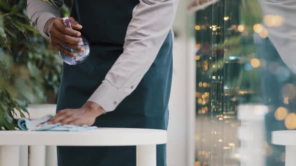 Closeup Man Unrecognizable Man Waiter in Apron Cleaning in Cafe Young African American Barista alt