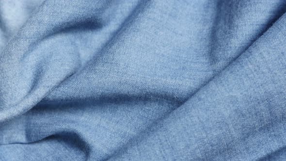 Blue high quality denim details and texture  close-up tilting 4K 2160p 30fps UltraHD video - Dugaree alt