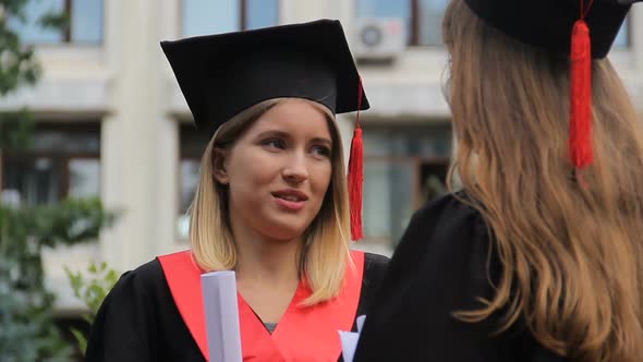 Two Graduate Students Standing Near University and Talking About Future Career alt