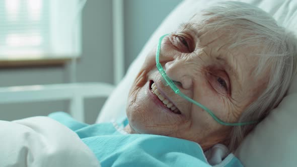 Portrait of Smiling Senior Woman with Nasal Cannula in Hospital by ...