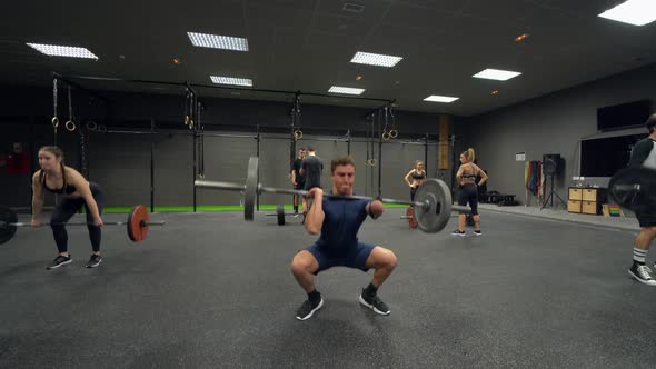 Athletes doing weight lift training at gym