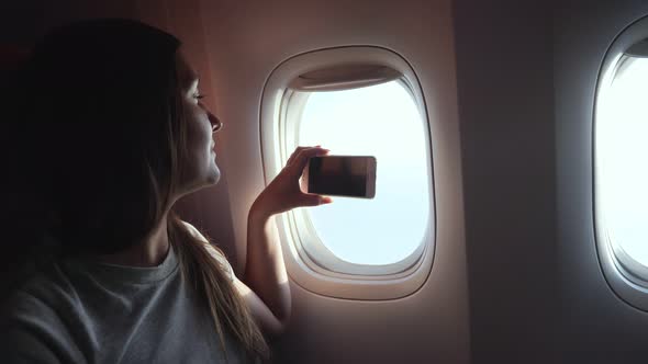 Girl Makes Video on Phone Outside Passenger Cabin Closeup alt