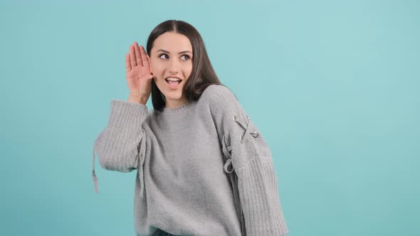 Close Up of a Curious Young Woman Try To Hear You with Hand Near Ear. alt