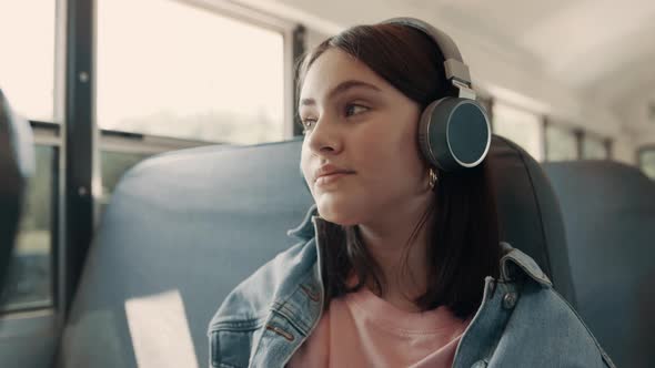 Teenage Girl Enjoying Listening Music with Headphones Sitting Bus Close Up alt