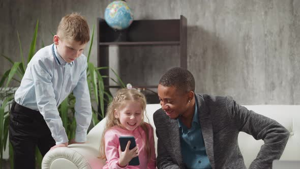 Girl Watches Funny Videos Via Phone with Brother and Teacher alt
