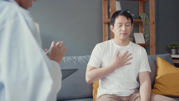 Young Asia female physician doctor wear face mask using digital tablet sharing good health test. alt