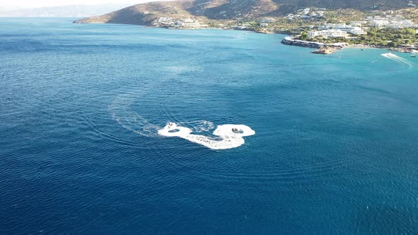 Aerial View of a Jet Ski Boat in a Deep Blue Colored Sea. Spinalonga Island, Crete, Greece