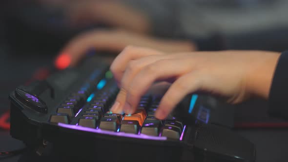 Close-up of a Teenager's Hand Quickly Presses Buttons on the Keyboard During Online Video Games alt