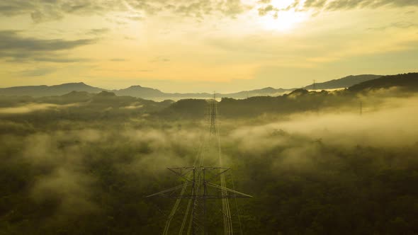 Aerial views, mountains and clouds with High-voltage power pole,