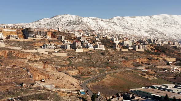 Hermon mountain ridge covered with snow during 2022 winter, with the town houses of Majd al Shams. alt