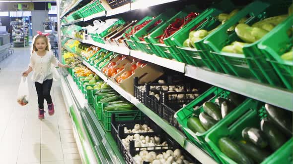 Funny Happy Little Girl Shopping in the Supermarket  Slow Motion alt