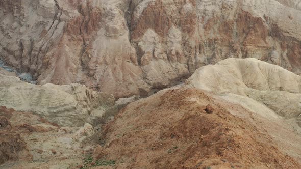 Aerial  fly over a creek between red desert mountains in Israel Judea desert alt