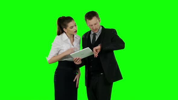 Two Office Worker Look at a Laptop Together. Green Screen alt