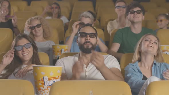 Happy Cinema Visitors Laughing, Taking Off 3d Glasses and Leaving. Multiethnic Men and Women Walking alt