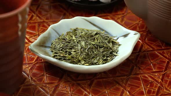 Japanese dried green tea leaves on a small dish  alt